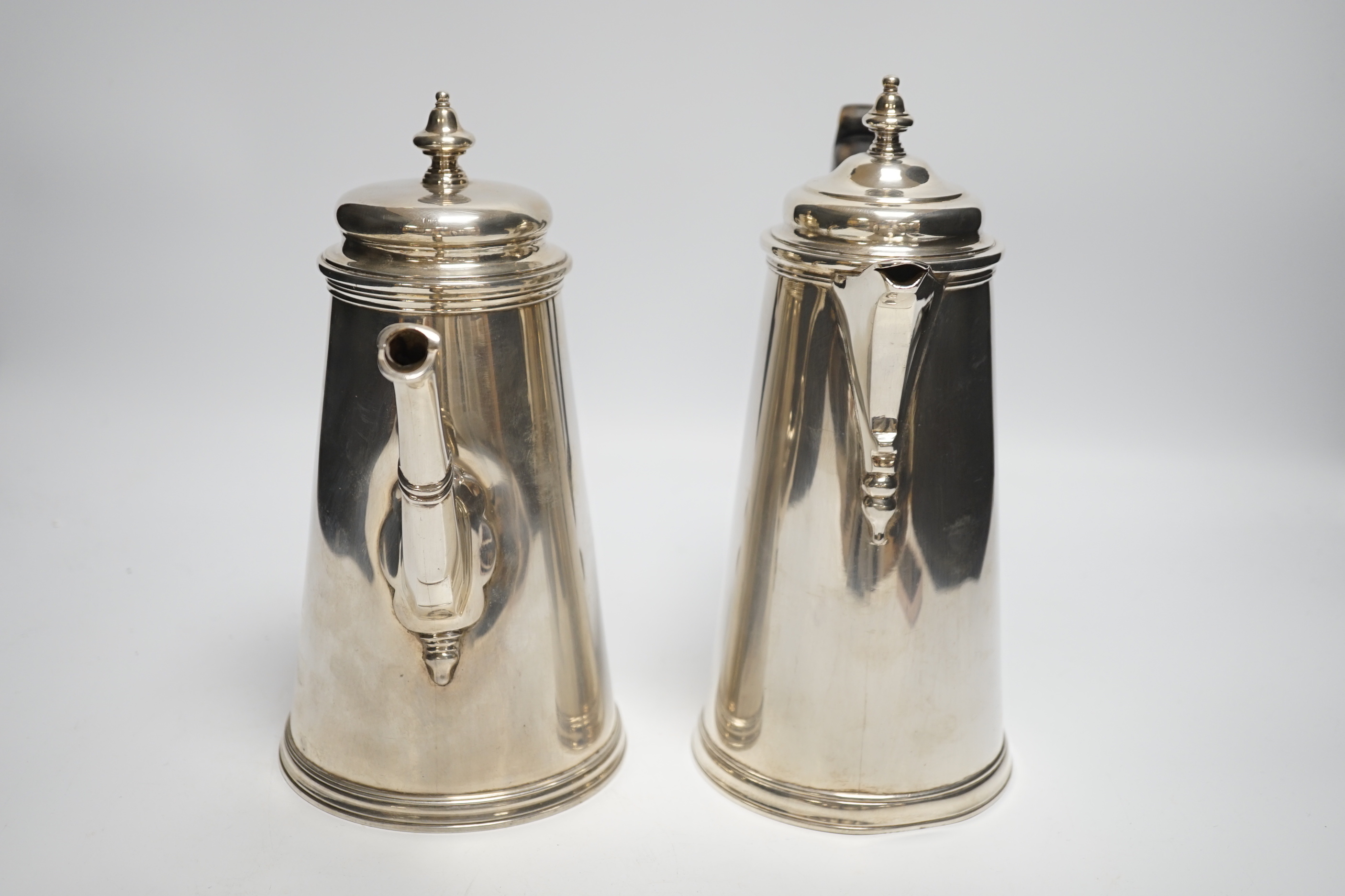 A pair of George V silver cafe au lait pots, Daniel & John Welby, London, 1916/18, handle missing, gross weight 54oz.